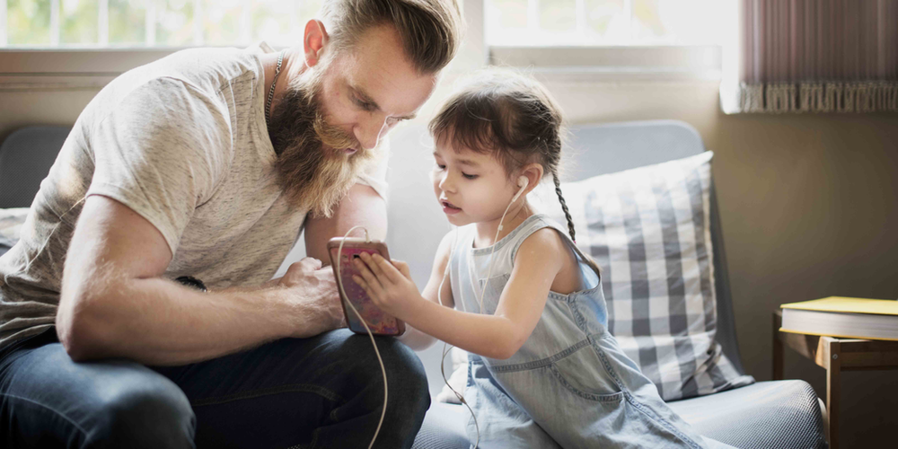 Dad and daughter listening to music together