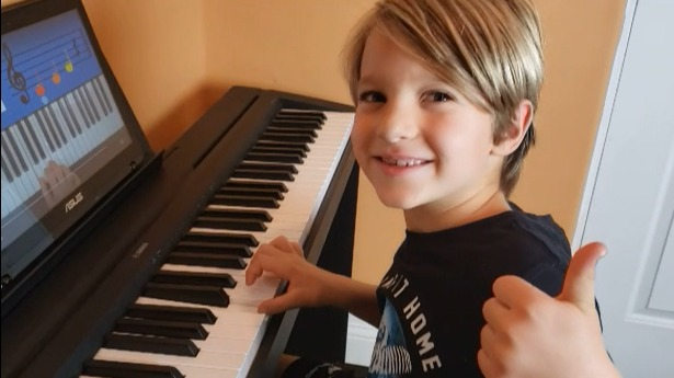 Boy learning piano wth my music workshop piano lesson