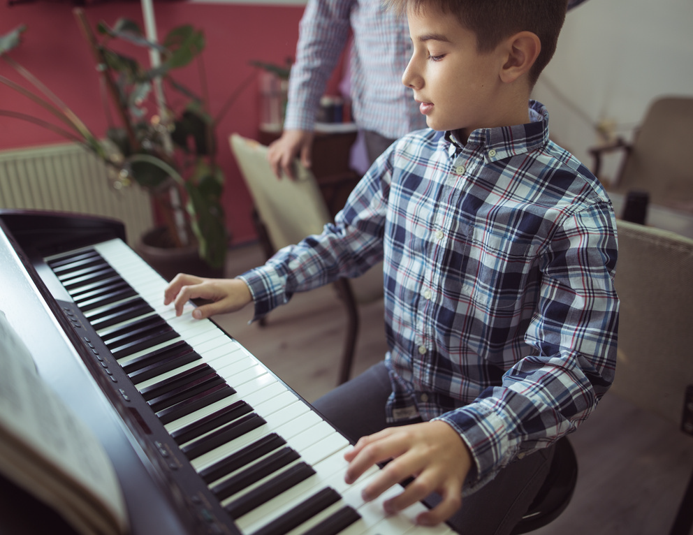 Boy learning piano